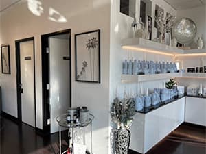 Modern retail shop interior with glass shelving and white vases, renovated by Jeff Smith Construction in Citrus Heights, CA.