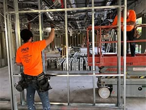 Jeff Smith Construction crew setting up a steel frame structure inside a warehouse during a commercial build in Rancho Cordova, CA.
