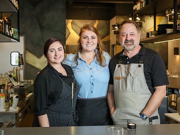 Restaurant staff working inside a finished dining space constructed by Jeff Smith Construction in Folsom, CA.