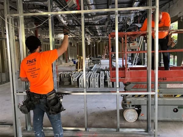 Jeff Smith Construction crew setting up a steel frame structure inside a warehouse during a commercial build in Rancho Cordova, CA.